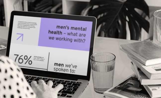 Person learning about men's mental health on a laptop
